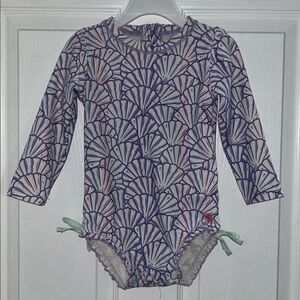 Rufflebutts Toddler Purple Shell Pattern Swimsuit. Mermaid themed.